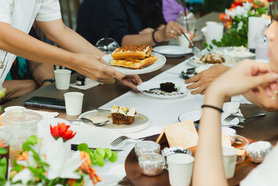Waitress serving belgian waffles to customer in cafe.