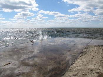 Scenic view of sea against cloudy sky