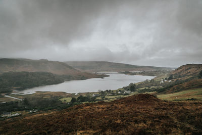 Scenic view of landscape and lake against sky