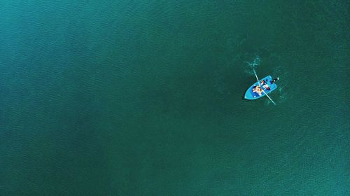 High angle view of man in rowboat at sea