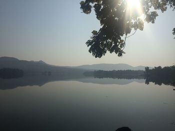 Scenic view of lake against clear sky during sunset