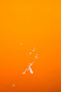 Orange paint peeling off from wall