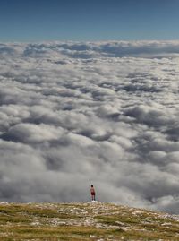 Person looking at cloudscape from the top of the mountain