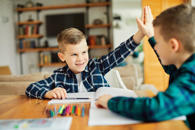 Portrait of boy sitting on table