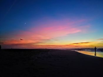 Scenic view of beach against sky during sunset