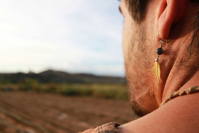 Close-up of man wearing earring