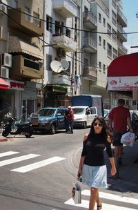 Woman standing on street in city