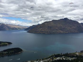 Scenic view of sea and mountains against sky