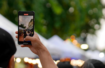 Cropped hands of woman using mobile phone