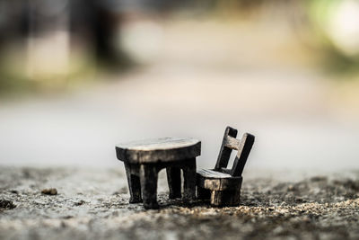 Close-up of old wooden table on field