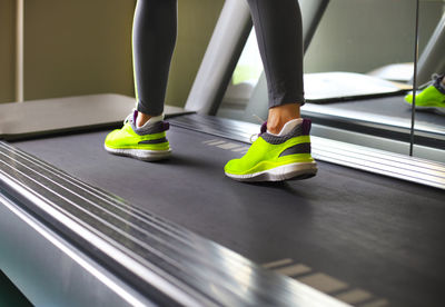 Low section of woman standing on exercise equipment