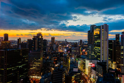 High angle view of illuminated buildings against sky during sunset