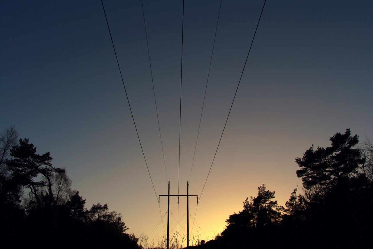 power line, silhouette, tree, electricity pylon, low angle view, electricity, power supply, sunset, cable, connection, sky, tranquility, clear sky, beauty in nature, nature, power cable, scenics, tranquil scene, dusk, fuel and power generation