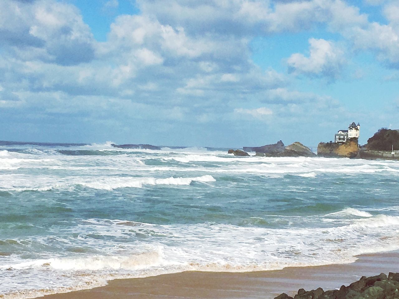 sea, water, beach, wave, horizon over water, surf, sky, shore, scenics, beauty in nature, cloud - sky, sand, nature, built structure, tranquil scene, tranquility, motion, coastline, cloudy, architecture