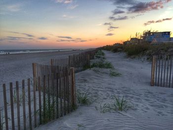 Scenic view of beach against sky during sunset