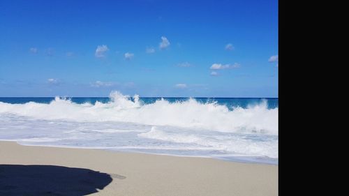Scenic view of beach against blue sky