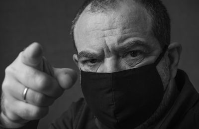 Close-up portrait of man covering face