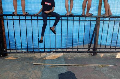 Low section of people standing by swimming pool