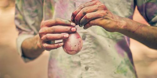 Midsection of man holding water balloon during holi