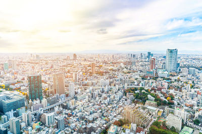 High angle view of modern buildings in city against sky