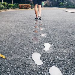 Low section of people walking on road