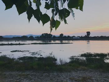 Scenic view of lake against sky during sunset