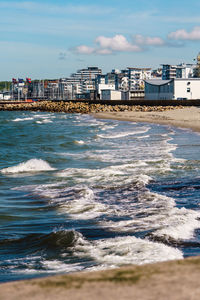 Scenic view of sea and buildings against sky