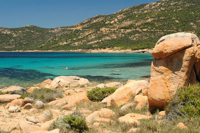 Scenic view of sea and mountains against sky