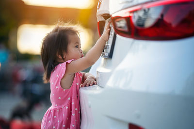 Little girl looks license plate the car