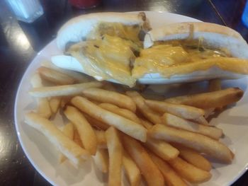 Close-up of meat and fries in plate