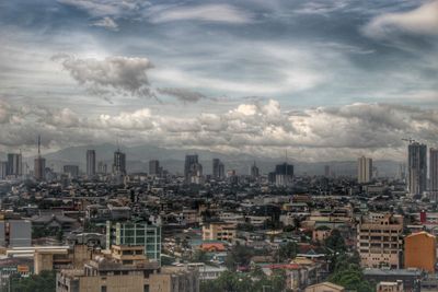 City buildings against cloudy sky