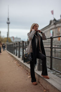 Full length of woman standing on road