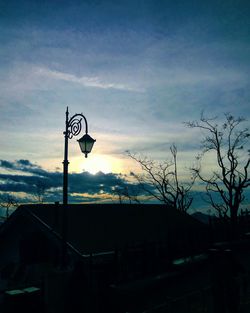 Road sign against sky during sunset
