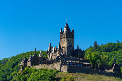 Low angle view of historical building against clear blue sky