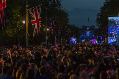 Crowd at music concert in city at night