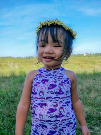 Portrait of cute girl standing on field