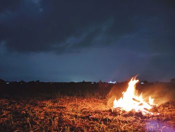 Bonfire on field against sky