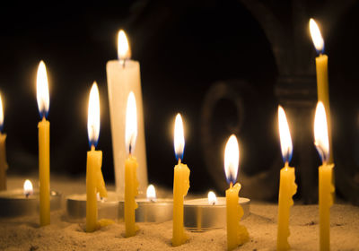 Close-up of burning candles at church