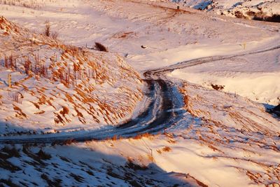 Road by mountain against sky
