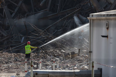 Rear view of people working at construction site