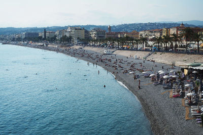 High angle view of people on beach against buildings in city