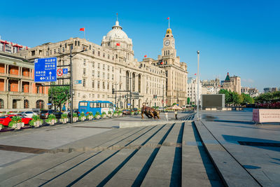 Buildings in city against blue sky