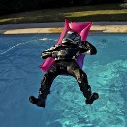High angle view of man jumping in swimming pool