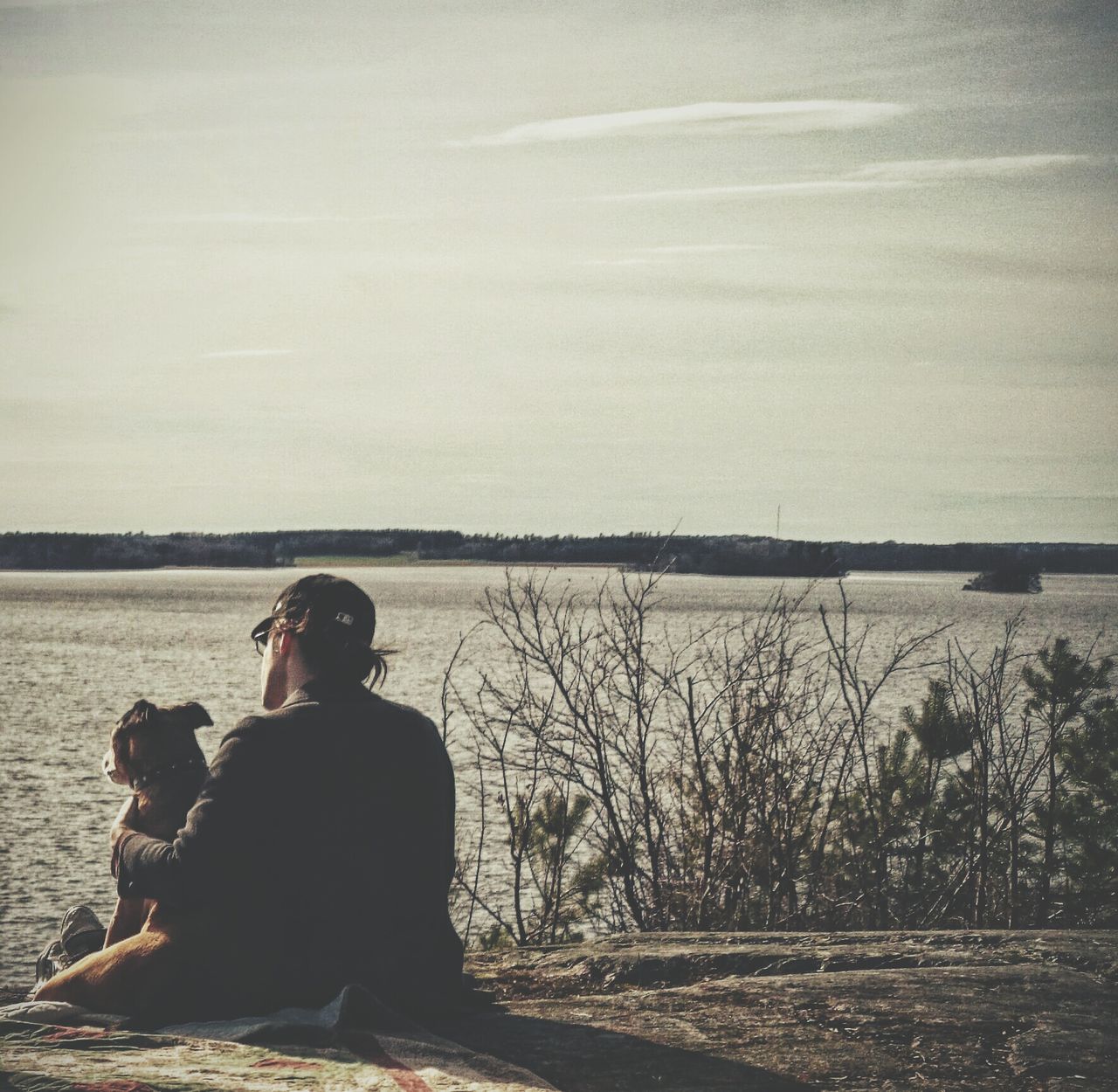 lifestyles, leisure activity, water, rear view, men, sitting, tranquility, standing, sky, tranquil scene, nature, scenics, waist up, beauty in nature, relaxation, looking at view, three quarter length, person