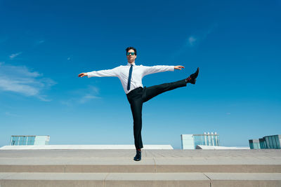 Full length of man standing on promenade against sky during sunset