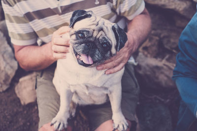 Midsection of man holding dog