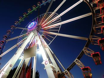 Low angle view of illuminated ferris wheel against sky at night