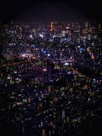 High angle view of illuminated city buildings at night