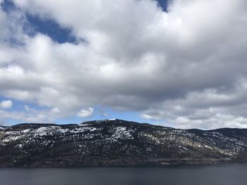 Scenic view of sea and mountains against sky