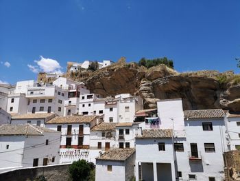 Low angle view of buildings against blue sky